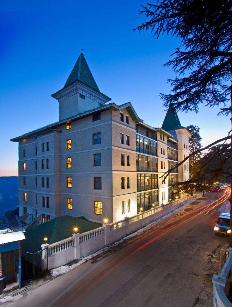 a building with a tower on top of a street at The Oberoi Cecil in Shimla