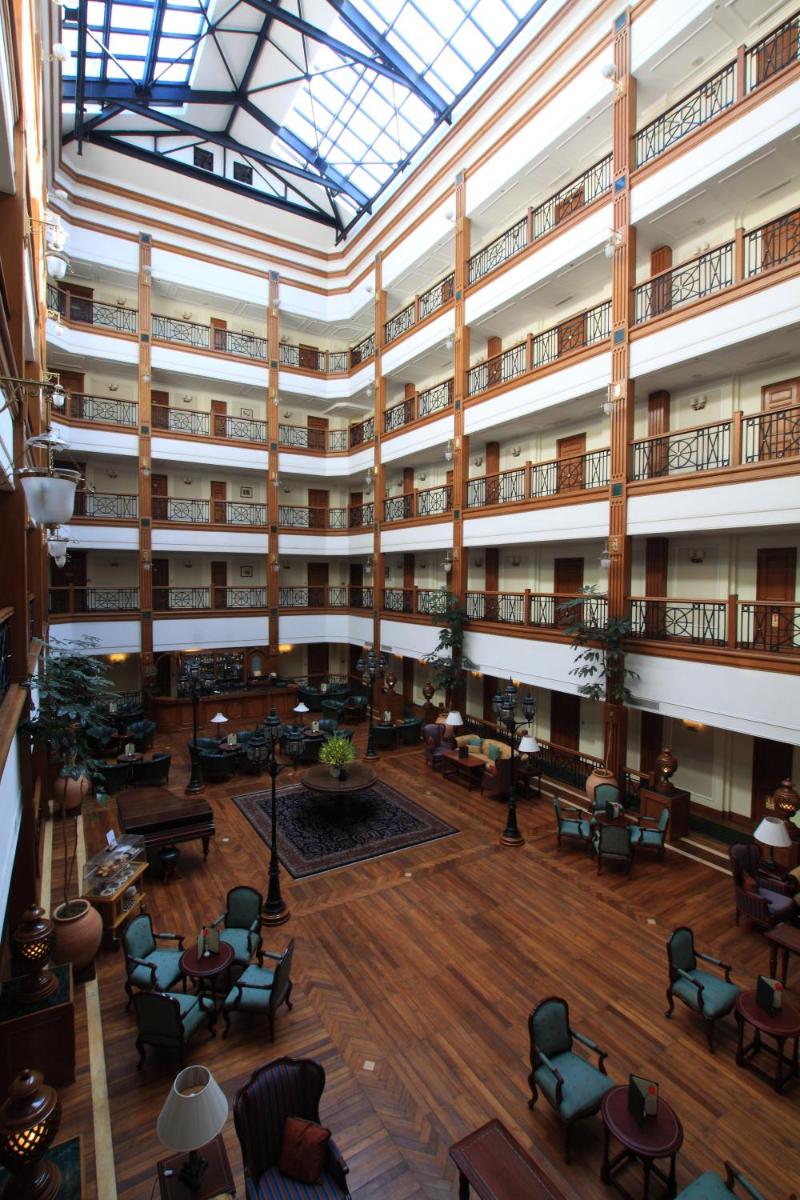 an image of a large building with tables and chairs at The Oberoi Cecil in Shimla