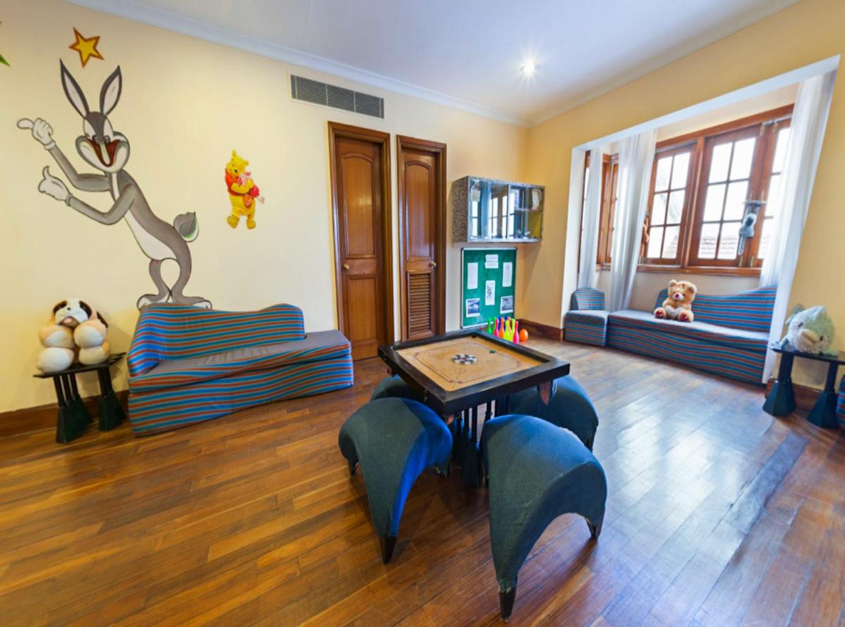 a childrens room with a table and a game table at The Oberoi Cecil in Shimla