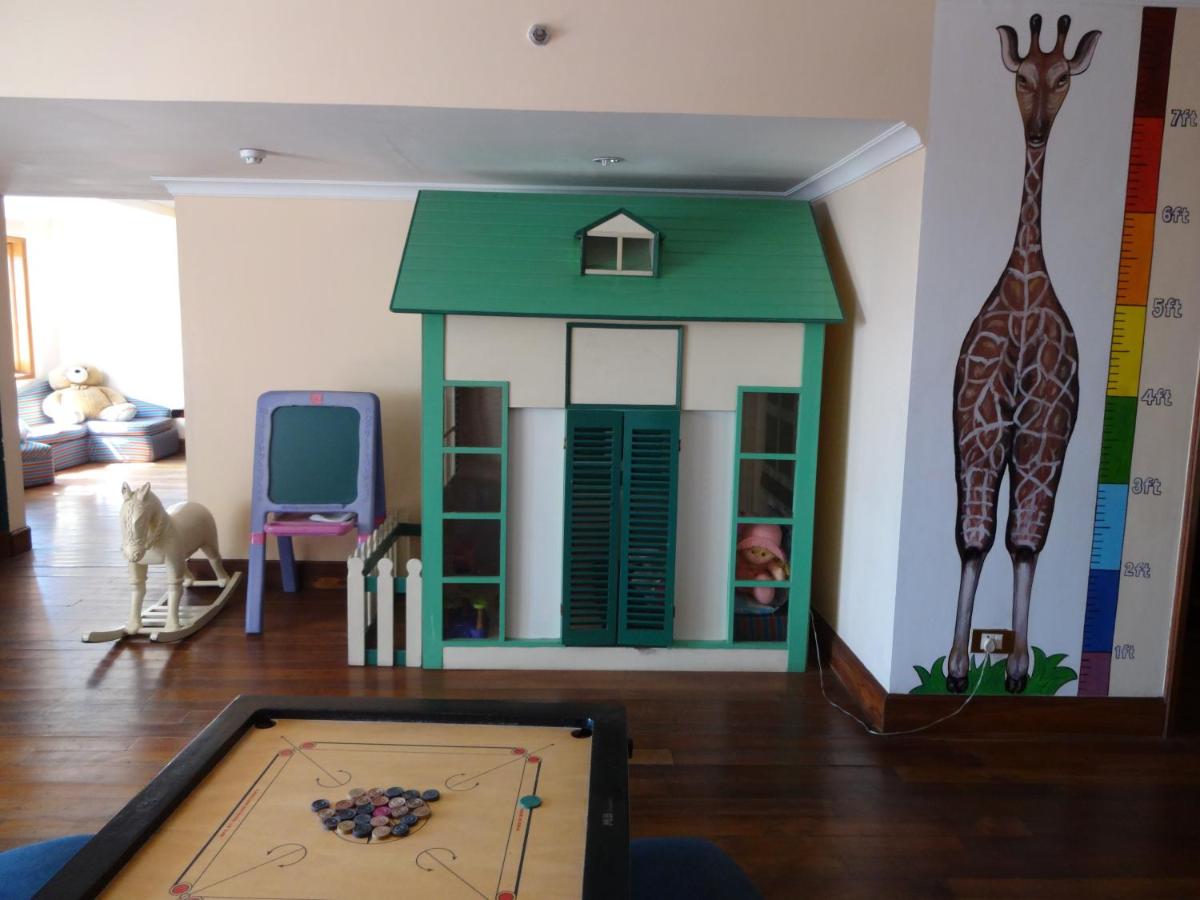 a room with a toy giraffe and a table at The Oberoi Cecil in Shimla