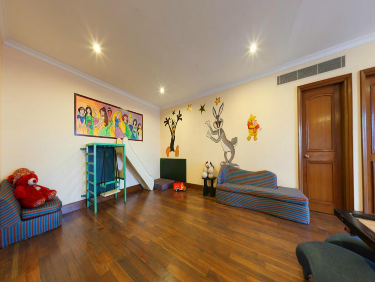 a living room with a couch and a fireplace at The Oberoi Cecil in Shimla