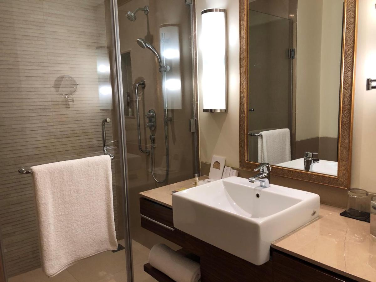 a bathroom with a sink and a shower with a mirror at DoubleTree by Hilton Agra in Agra