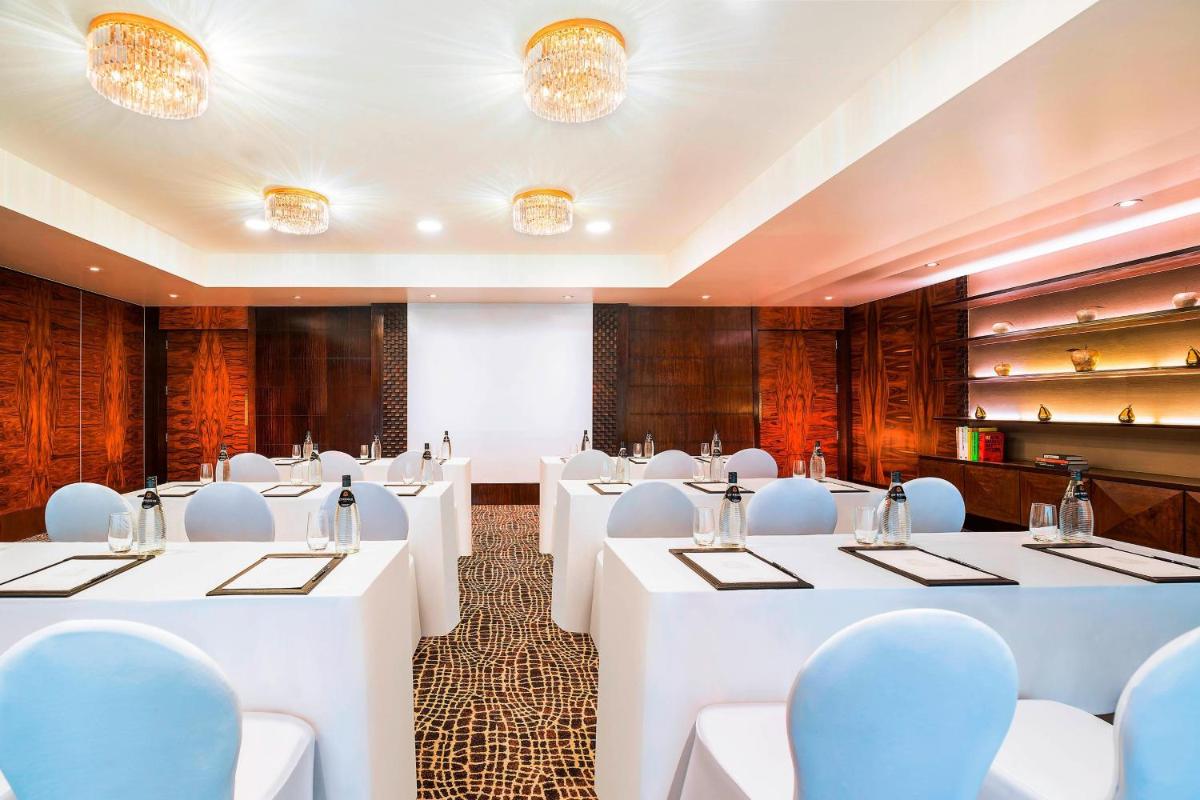 a conference room with white tables and chairs at The St. Regis Mumbai in Mumbai