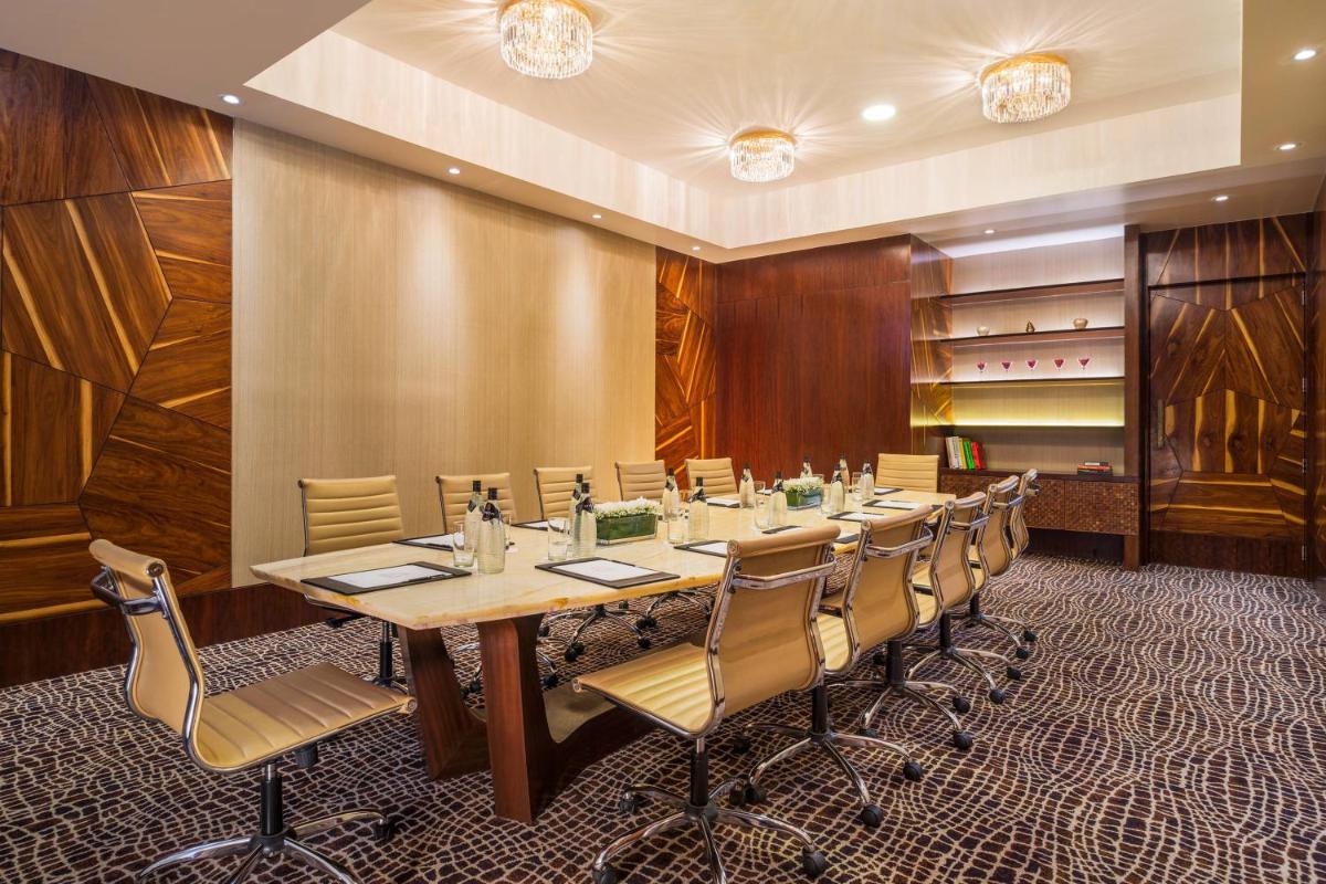 a conference room with a long table and chairs at The St. Regis Mumbai in Mumbai