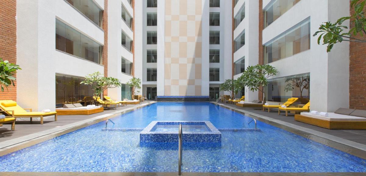a swimming pool in the middle of a building at Sheraton Hyderabad Hotel in Hyderabad