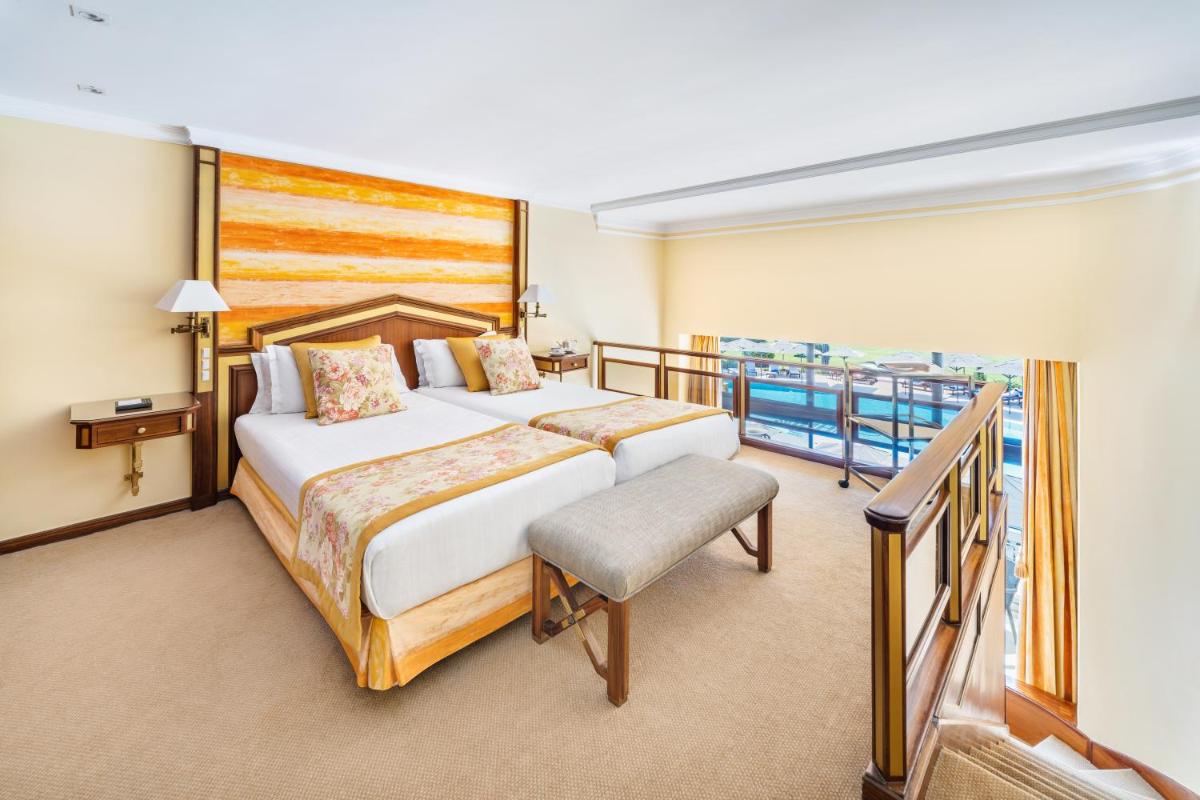 Uma cama ou camas num quarto em Palácio Estoril Hotel, Golf & Wellness