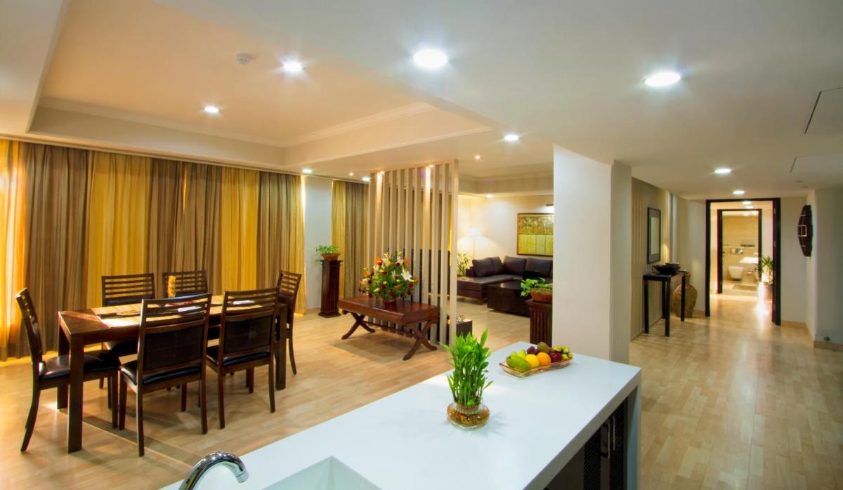 a dining room and living room with a table and chairs at The Piccadily in Lucknow