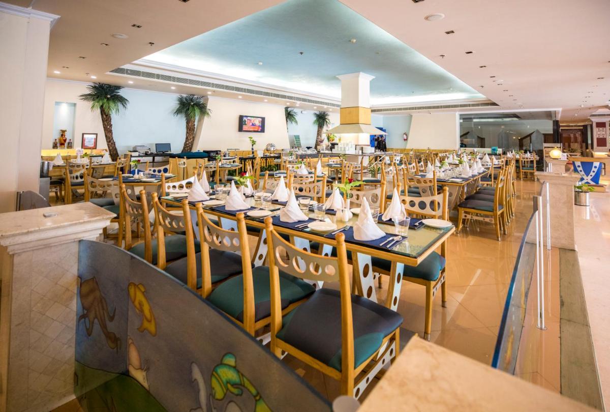 a large dining room with tables and chairs at The Piccadily in Lucknow