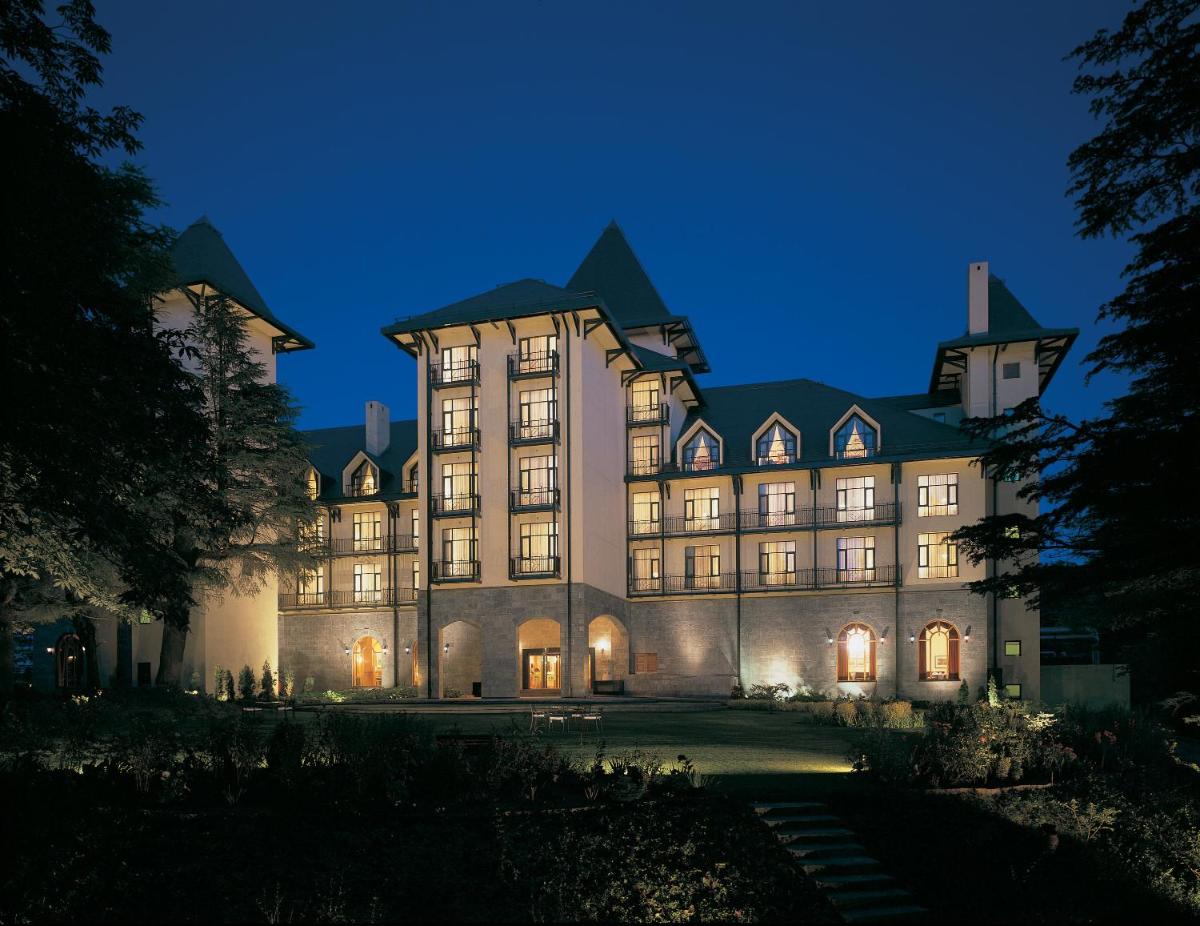 a large building at night with its lights on at Wildflower Hall, An Oberoi Resort, Shimla in Shimla