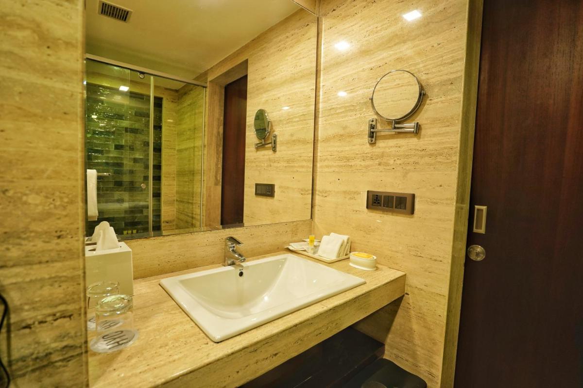 a bathroom with a sink and a mirror at Hyatt Centric Rajpur Road Dehradun in Dehradun