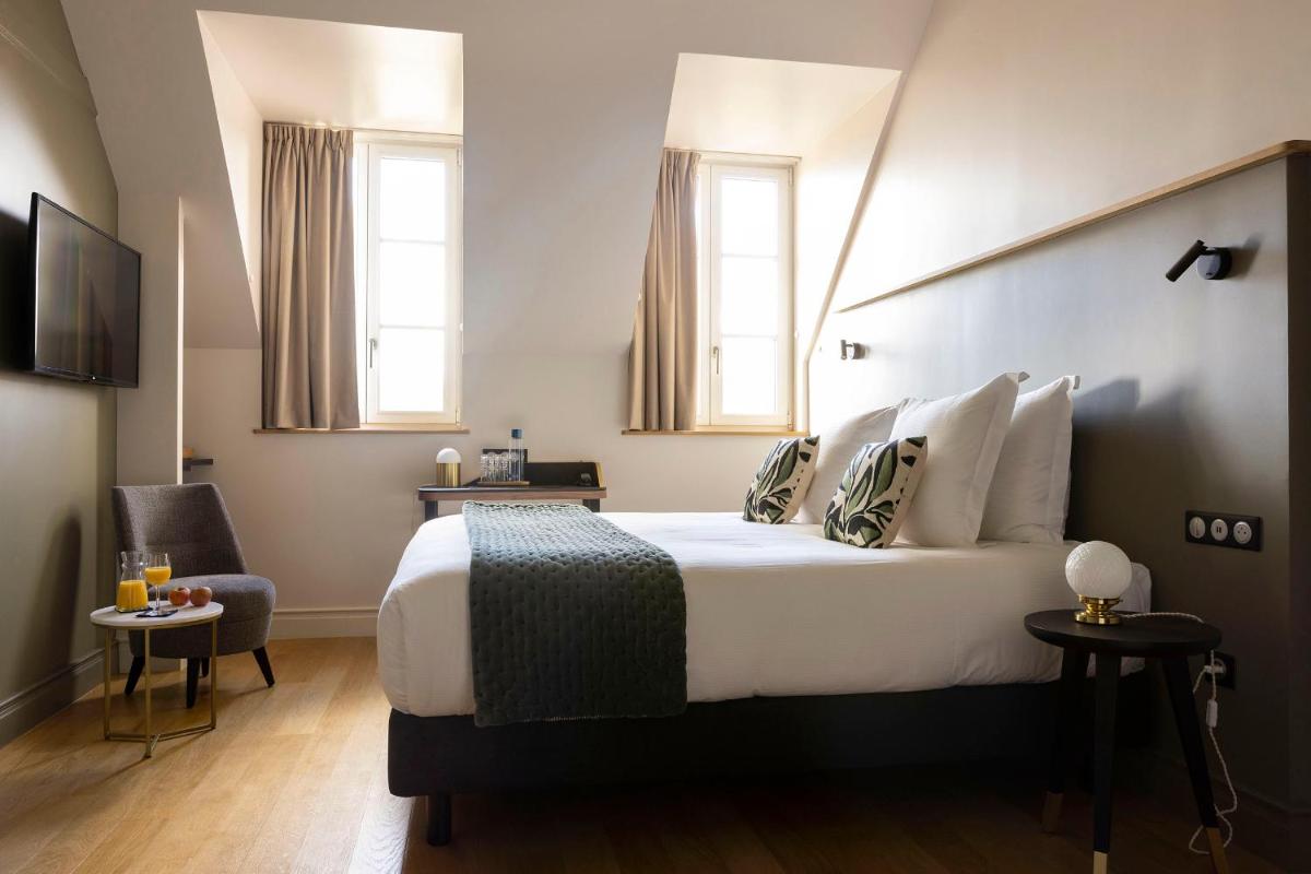 Un ou plusieurs lits dans un hébergement de l'établissement L'INVITATION AU VOYAGE - Hôtel & Spa