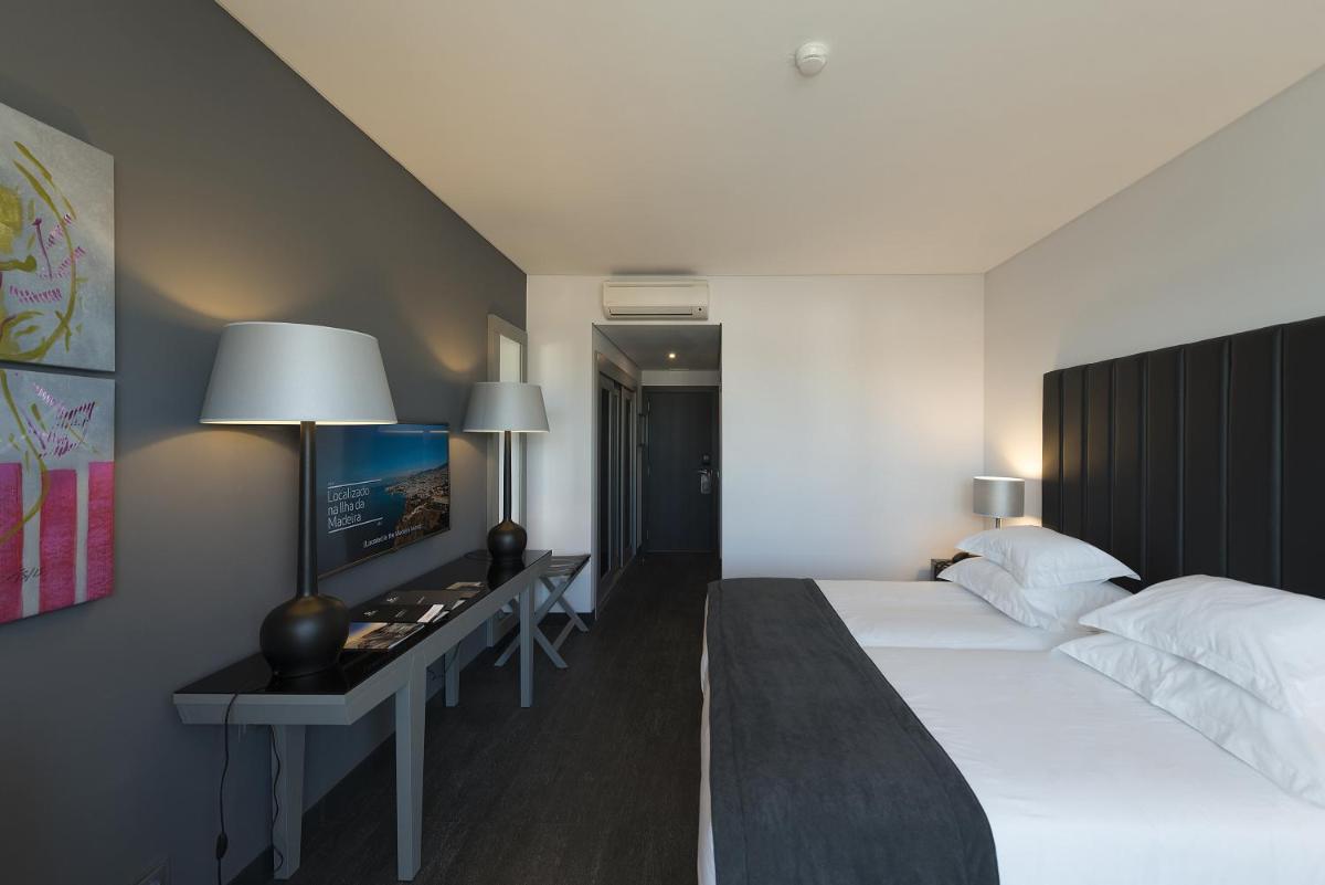 Uma cama ou camas num quarto em Vila Gale Evora