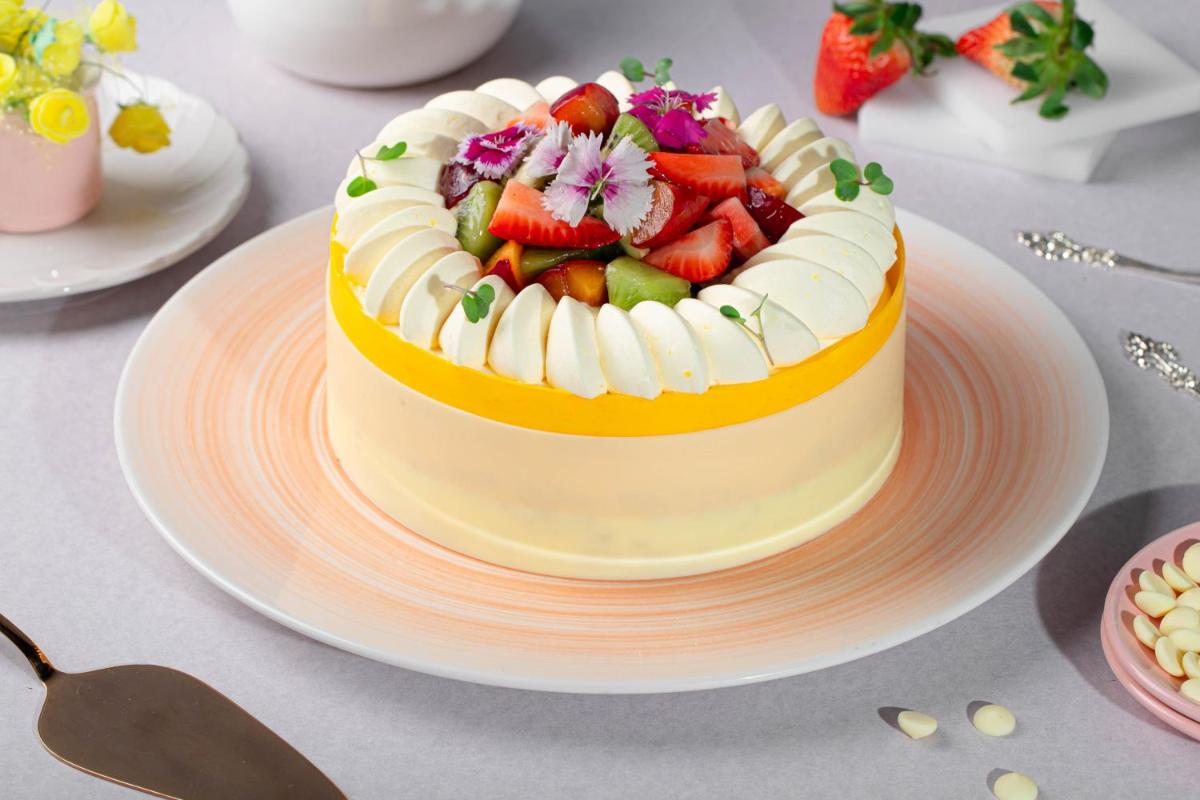 a cake with fruit on a plate on a table at JW Marriott Hotel New Delhi Aerocity in New Delhi a cake with fruit on a plate on a table at JW Marriott Hotel New Delhi Aerocity in New Delhi