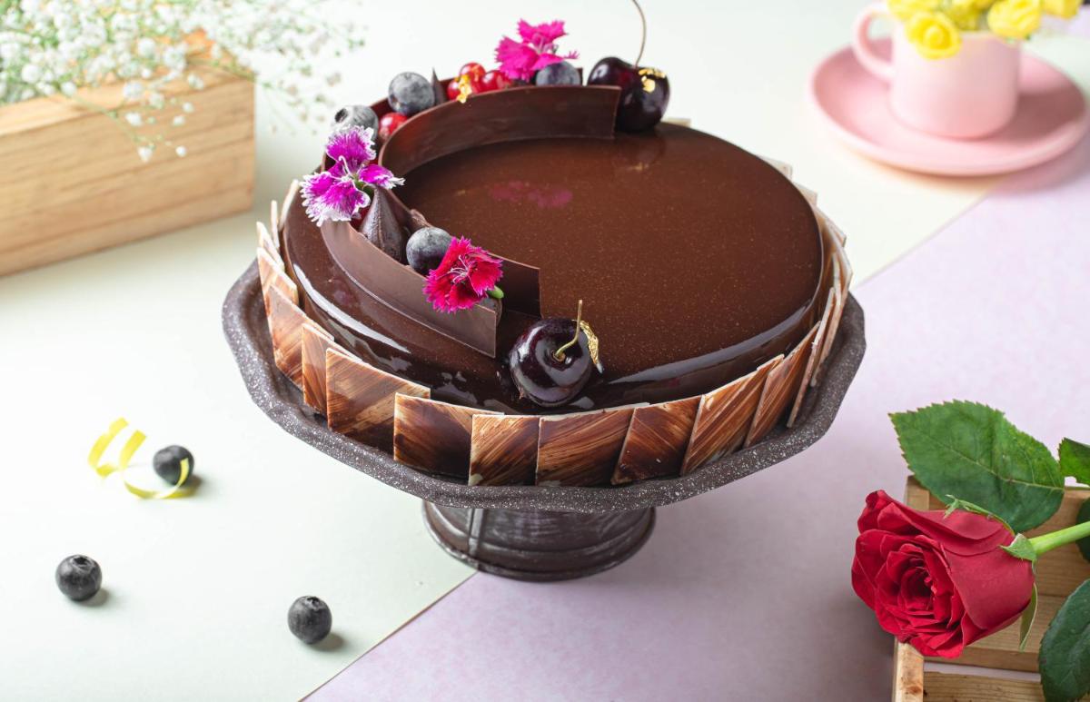 a chocolate cake sitting on top of a table at JW Marriott Hotel New Delhi Aerocity in New Delhi a chocolate cake sitting on top of a table at JW Marriott Hotel New Delhi Aerocity in New Delhi