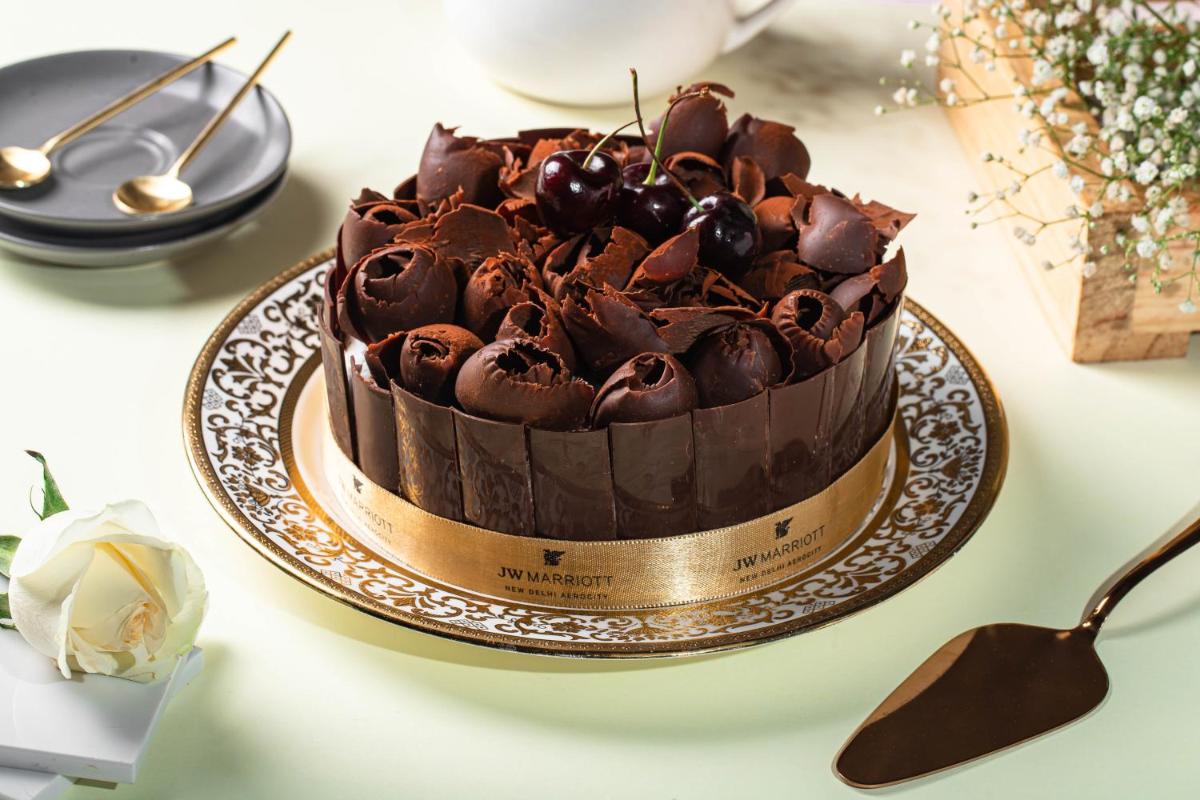 a chocolate cake on a plate on a table at JW Marriott Hotel New Delhi Aerocity in New Delhi a chocolate cake on a plate on a table at JW Marriott Hotel New Delhi Aerocity in New Delhi