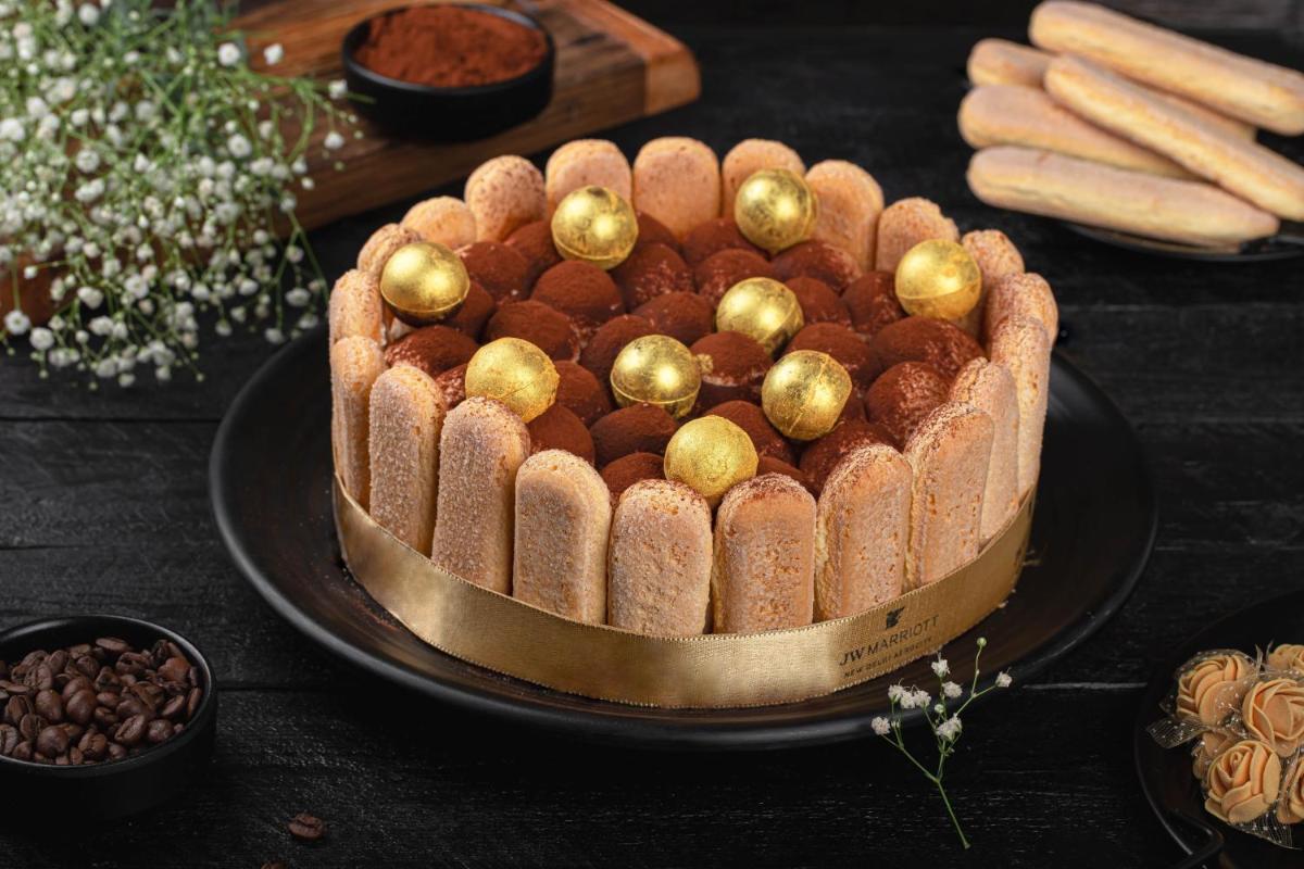 a chocolate cake with gold balls on a black plate at JW Marriott Hotel New Delhi Aerocity in New Delhi a chocolate cake with gold balls on a black plate at JW Marriott Hotel New Delhi Aerocity in New Delhi