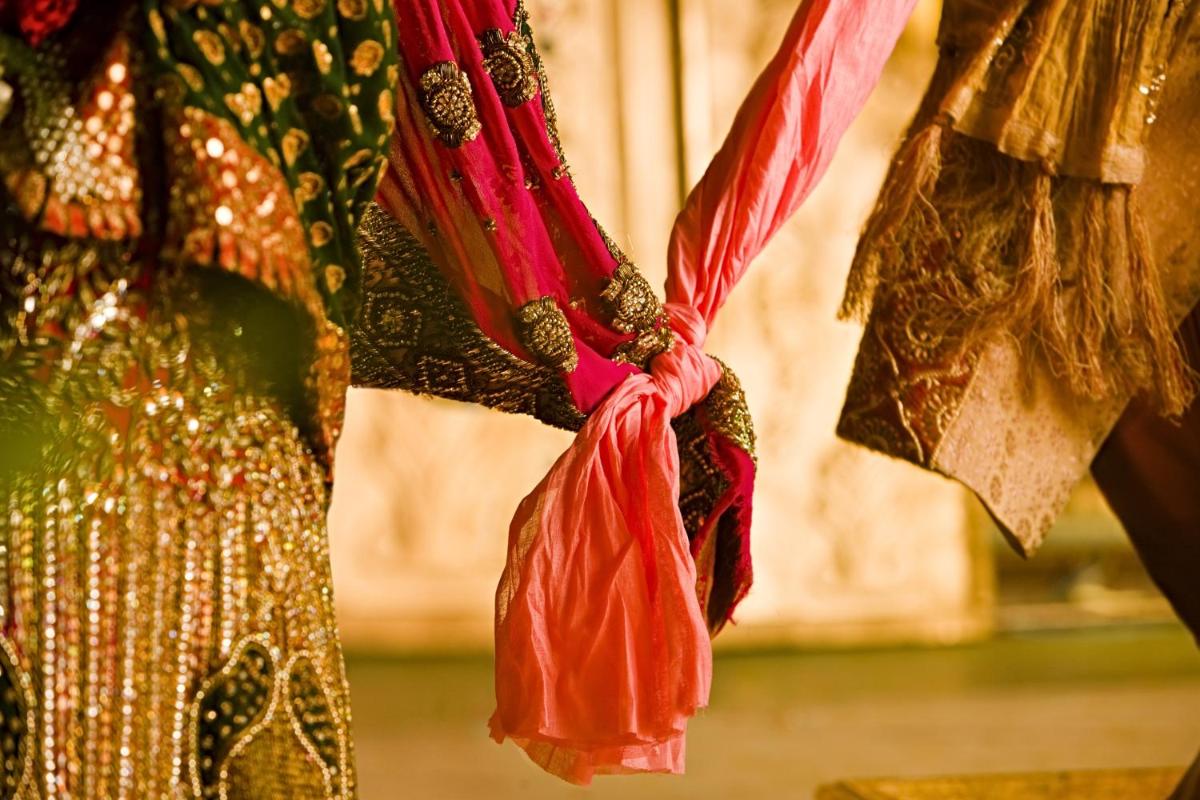 a group of colorful dresses hanging from a wall at JW Marriott Hotel New Delhi Aerocity in New Delhi a group of colorful dresses hanging from a wall at JW Marriott Hotel New Delhi Aerocity in New Delhi