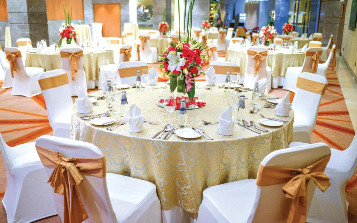a banquet hall with white tables and white chairs at JW Marriott Hotel New Delhi Aerocity in New Delhi a banquet hall with white tables and white chairs at JW Marriott Hotel New Delhi Aerocity in New Delhi