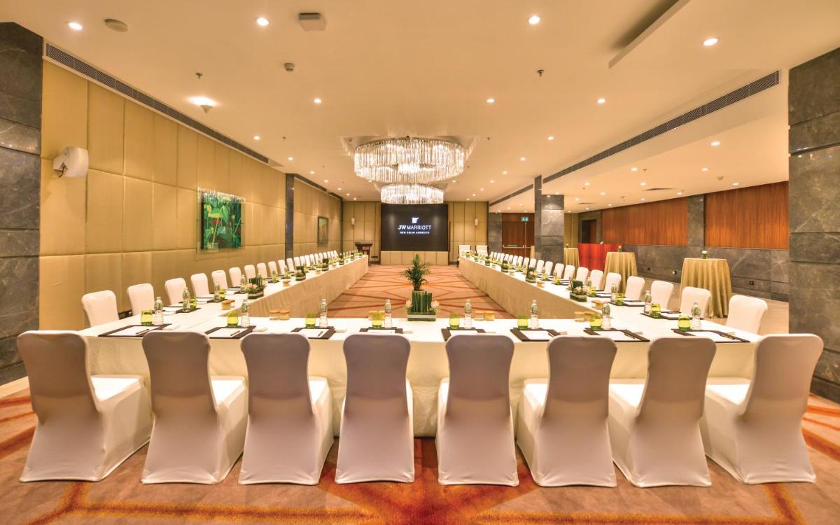 a large conference room with a long table and chairs at JW Marriott Hotel New Delhi Aerocity in New Delhi a large conference room with a long table and chairs at JW Marriott Hotel New Delhi Aerocity in New Delhi