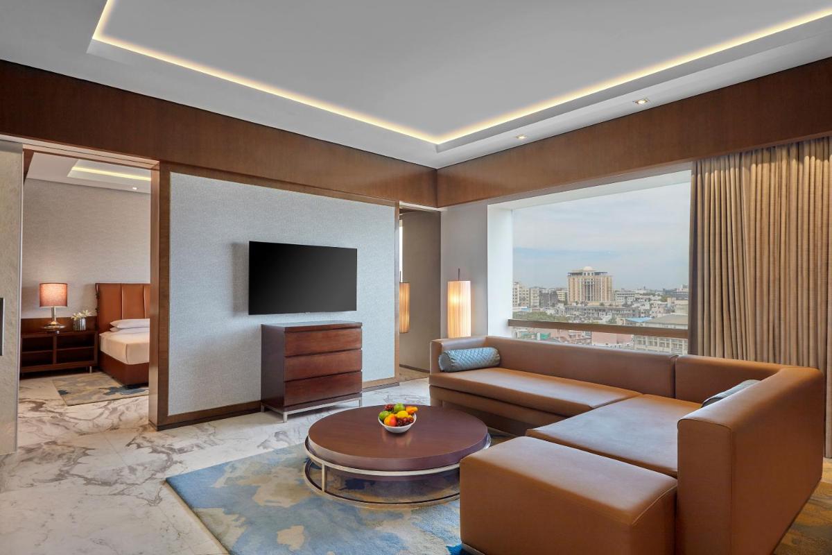 a living room with a couch and a television at Hyatt Regency Chennai in Chennai