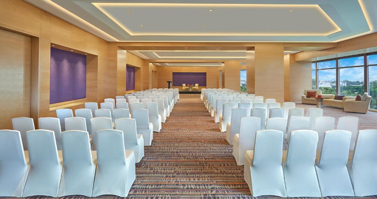 an empty room with white chairs in a conference room at Hyatt Regency Chennai in Chennai