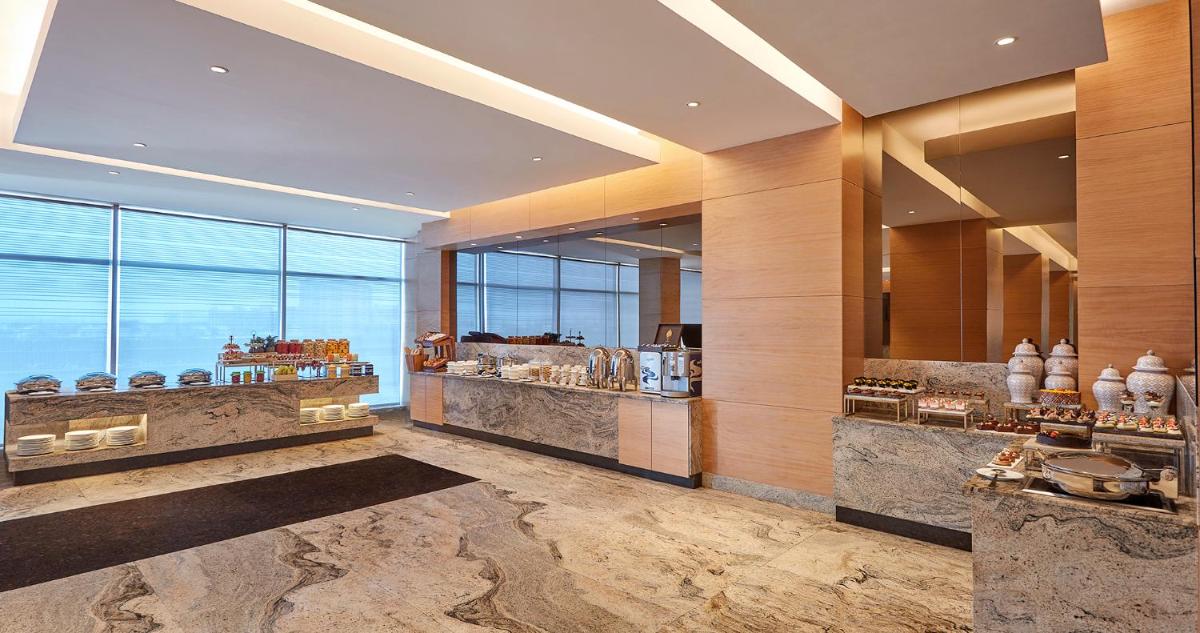 a hotel lobby with a large window and aasteryasteryasteryasteryasteryasteryastery at Hyatt Regency Chennai in Chennai