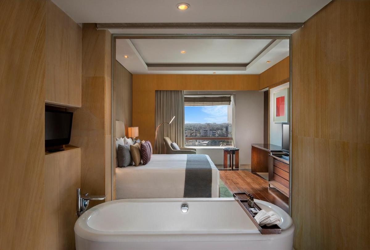 a bathroom with a bed and a tub in a room at Hyatt Regency Chennai in Chennai