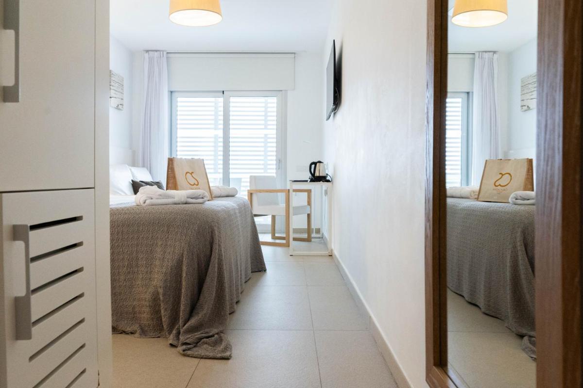Cama o camas de una habitación en Hotel Cala Saona & Spa