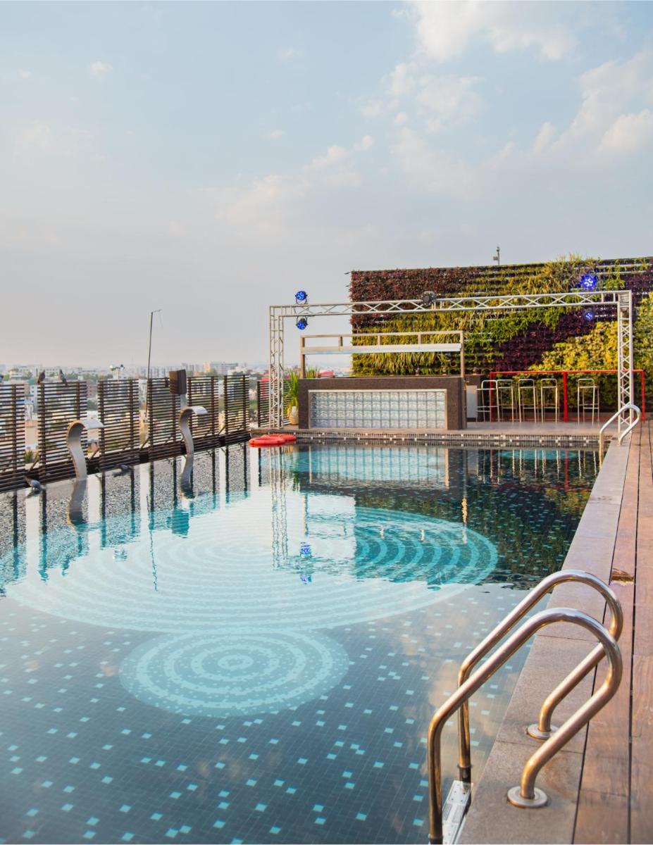 a swimming pool on the roof of a building at Hyatt Place Hyderabad Banjara Hills in Hyderabad