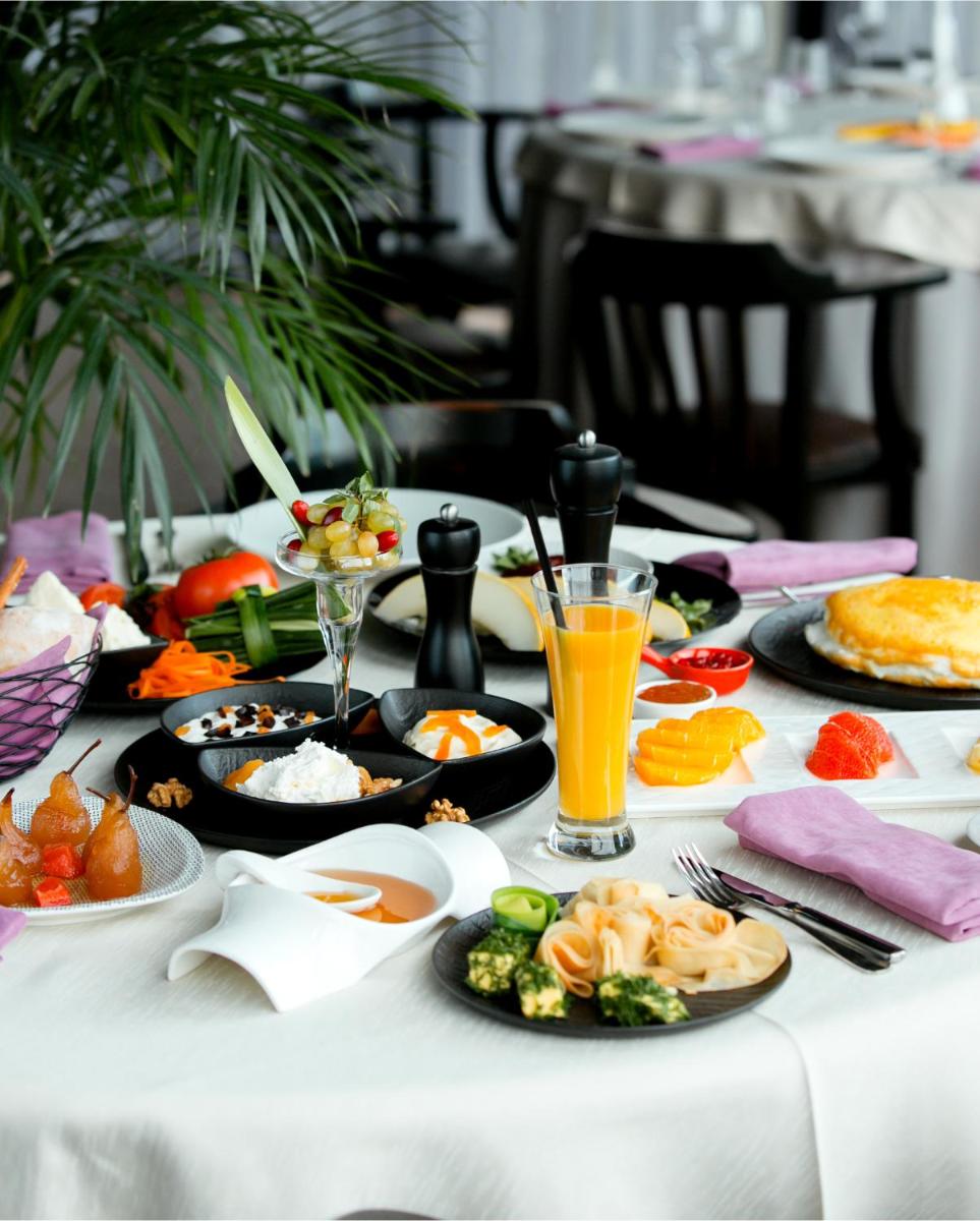 a table topped with plates of food and drinks at Hyatt Place Hyderabad Banjara Hills in Hyderabad