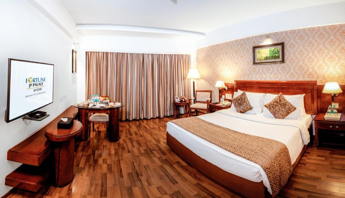 a hotel room with a bed and a flat screen tv at Fortune JP Palace, Mysore - Member ITC Hotels' Group in Mysore