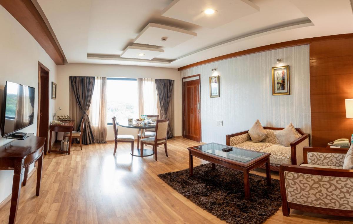 a living room with a couch and a table at Fortune JP Palace, Mysore - Member ITC Hotels' Group in Mysore