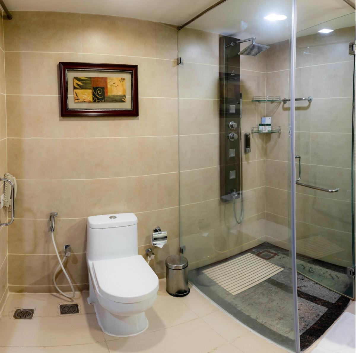 a bathroom with a toilet and a glass shower at Fortune JP Palace, Mysore - Member ITC Hotels' Group in Mysore