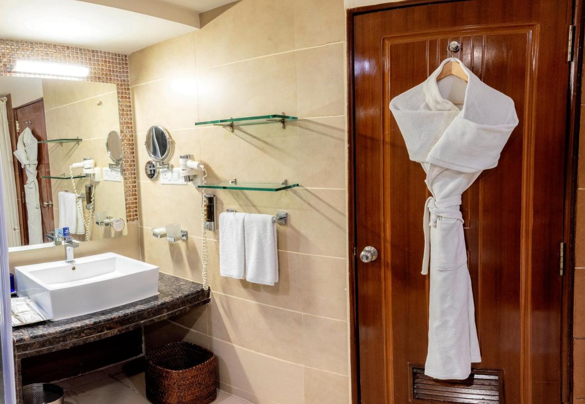 a bathroom with a sink and a mirror at Fortune JP Palace, Mysore - Member ITC Hotels' Group in Mysore