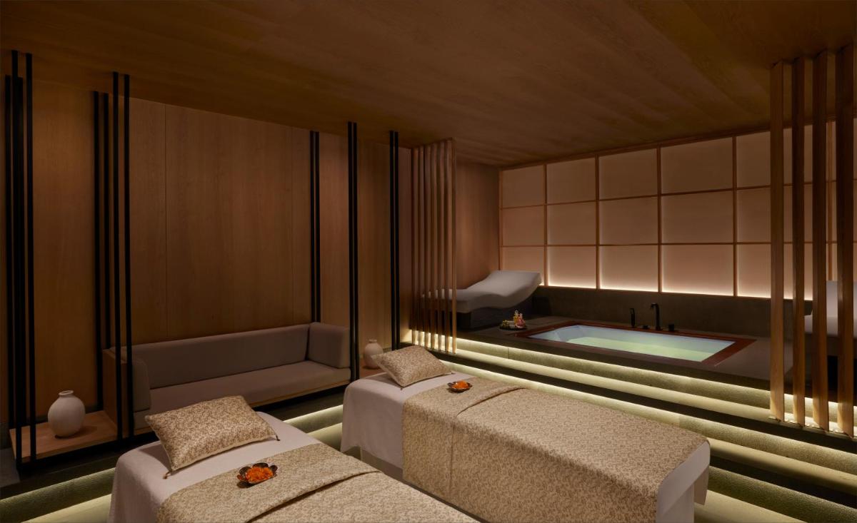 a room with two beds and a bath tub at Taj The Trees, Mumbai in Mumbai