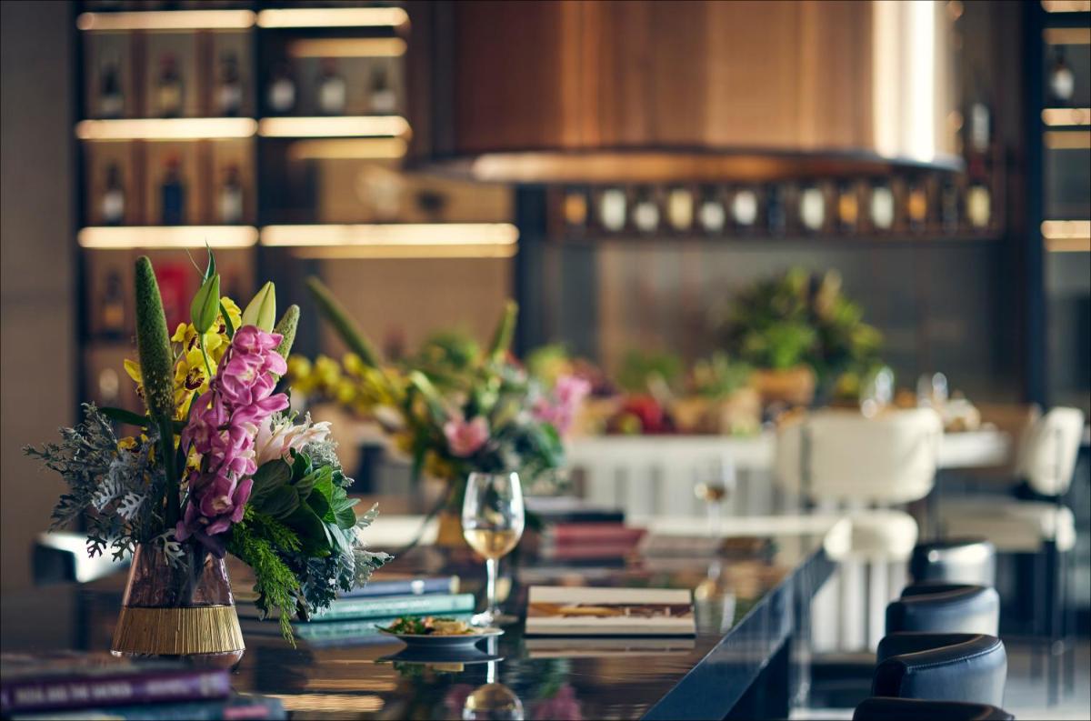 a table with a vase of flowers on it at Taj The Trees, Mumbai in Mumbai