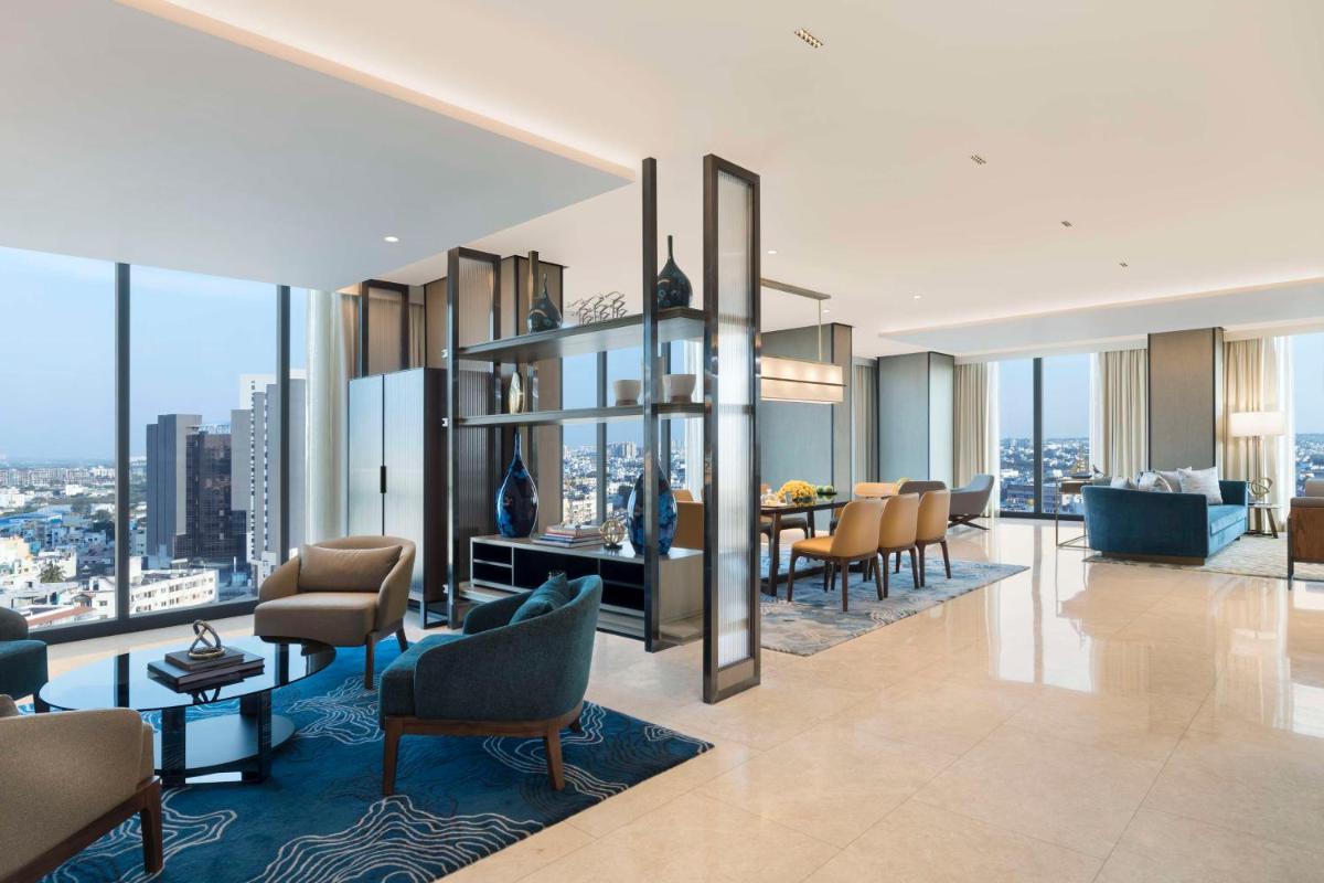 a living room with a view of a city at Hilton Bengaluru Embassy Manyata Business Park in Bengaluru