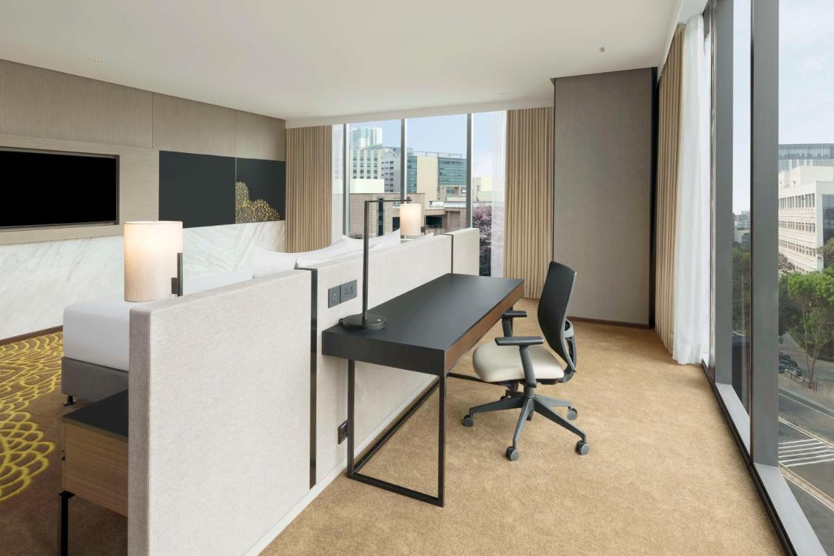 an office with a desk and a chair in a room at Hilton Bengaluru Embassy Manyata Business Park in Bengaluru