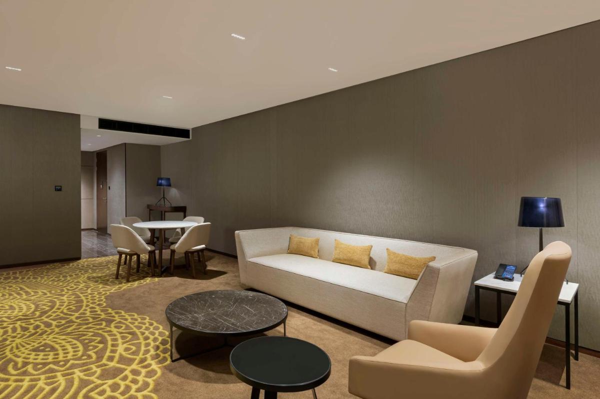 a living room with a couch and a table at Hilton Bengaluru Embassy Manyata Business Park in Bengaluru