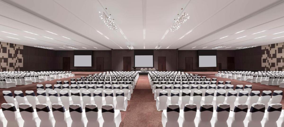 an empty room with rows of chairs in it at Hilton Bengaluru Embassy Manyata Business Park in Bengaluru