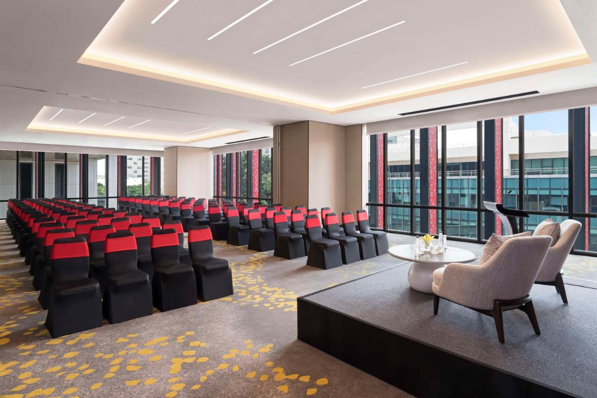 a conference room with red chairs and a table at Hilton Bengaluru Embassy Manyata Business Park in Bengaluru