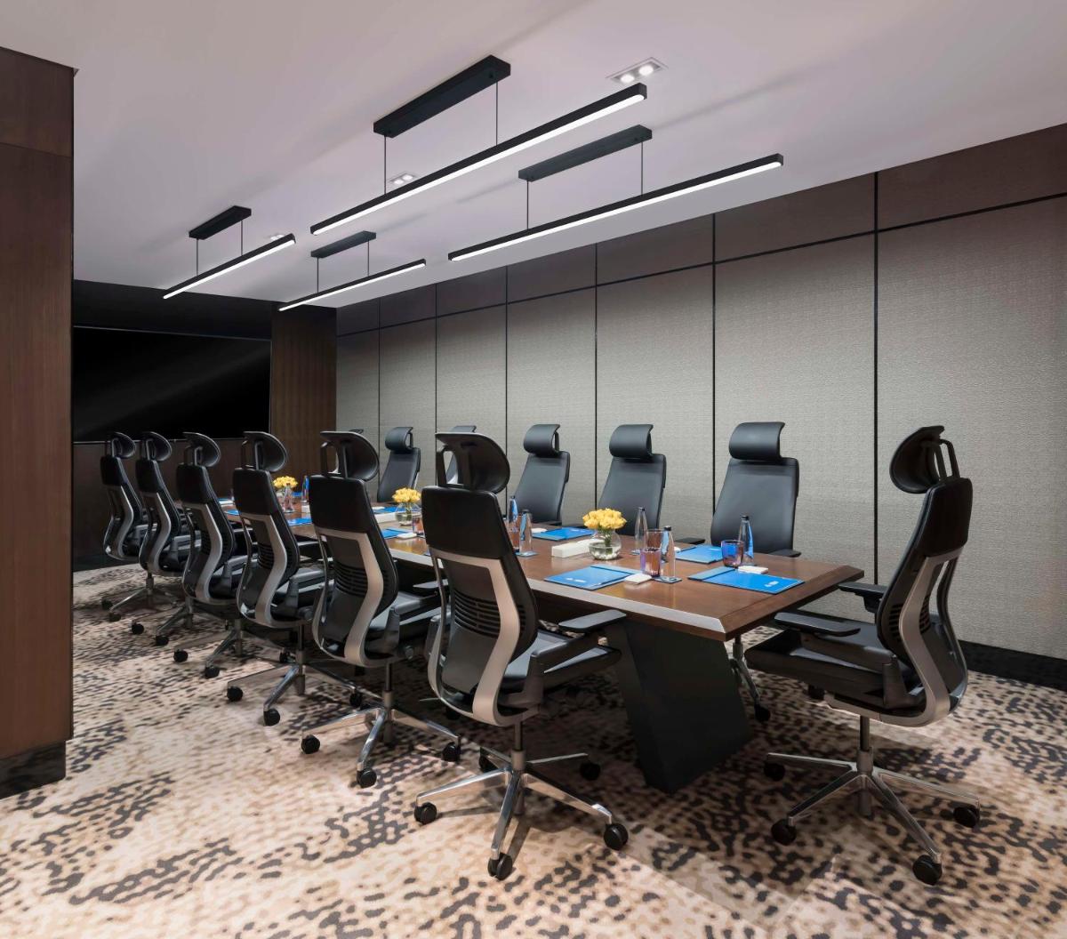 a conference room with a long table and chairs at Hilton Bengaluru Embassy Manyata Business Park in Bengaluru