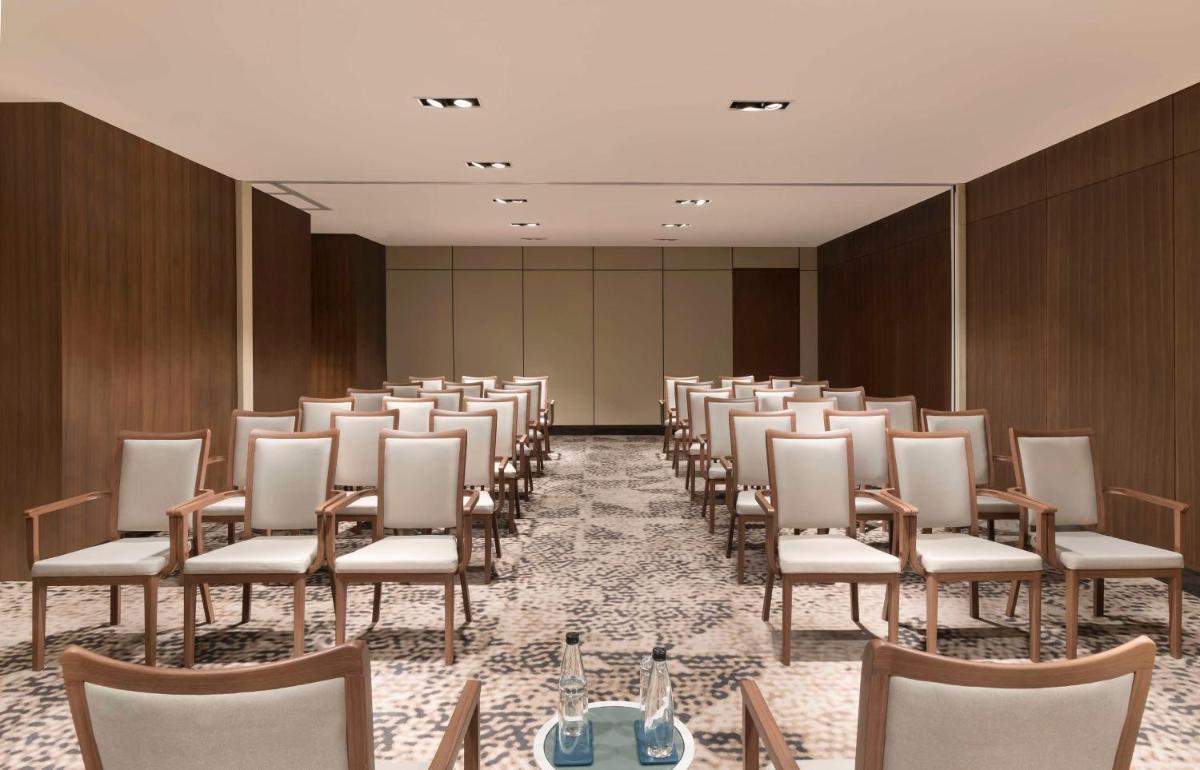 a room with a row of chairs and a table at Hilton Bengaluru Embassy Manyata Business Park in Bengaluru