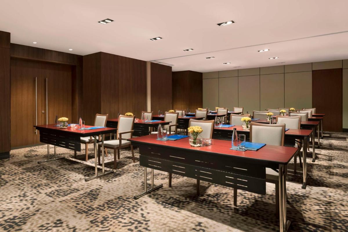 a conference room with tables and chairs in it at Hilton Bengaluru Embassy Manyata Business Park in Bengaluru