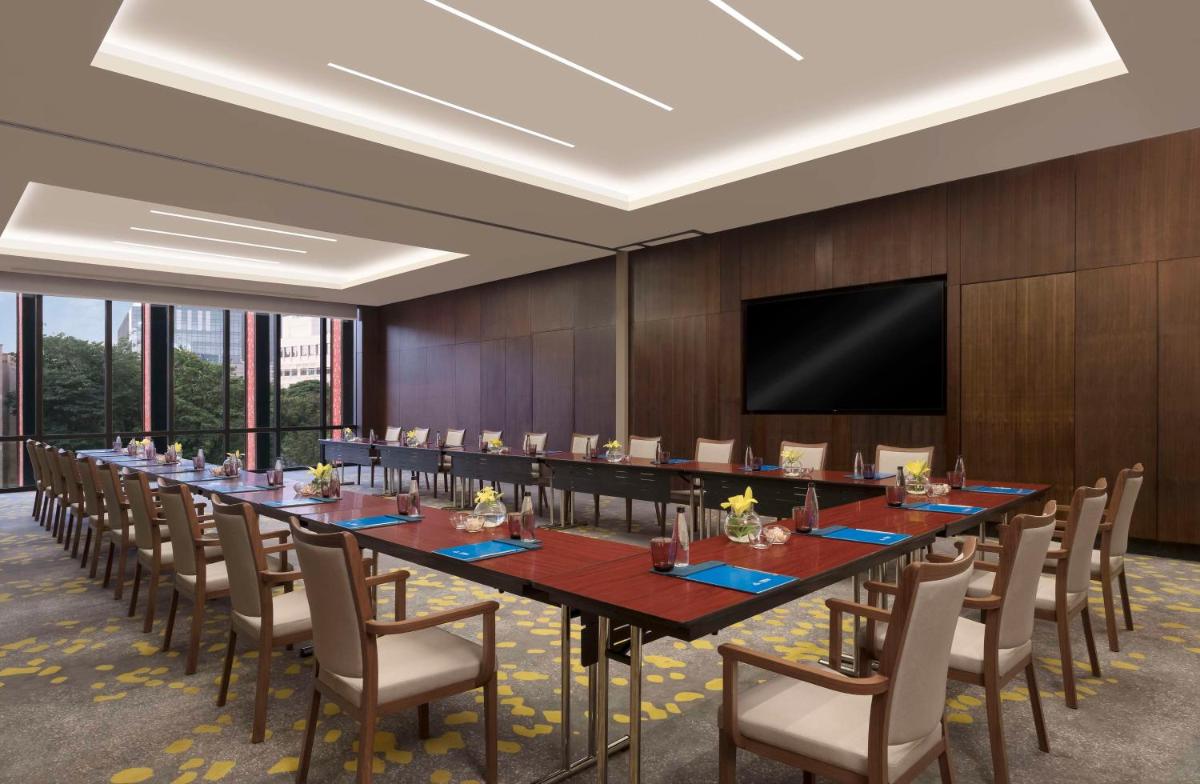 a large conference room with a long table and chairs at Hilton Bengaluru Embassy Manyata Business Park in Bengaluru