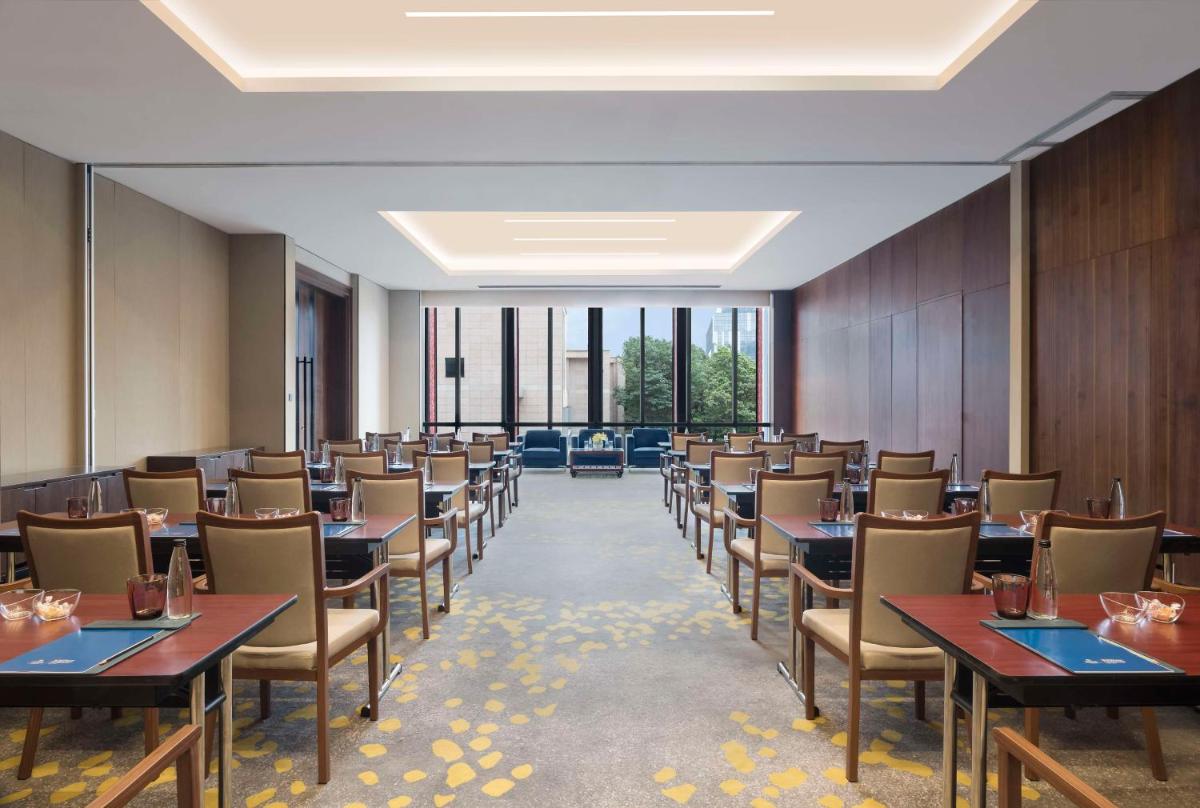 a large dining room with tables and chairs at Hilton Bengaluru Embassy Manyata Business Park in Bengaluru