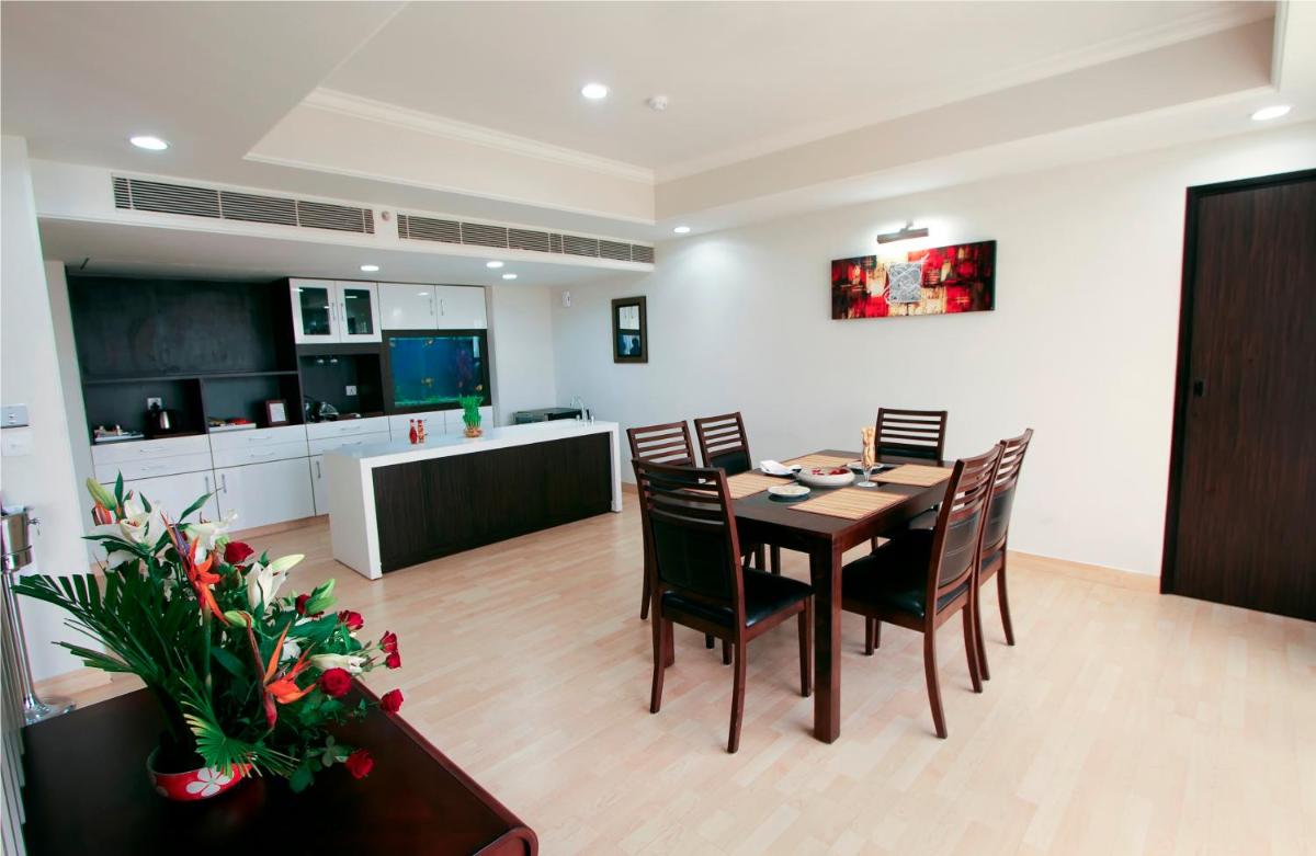 a kitchen and dining room with a table and chairs at The Piccadily in Lucknow