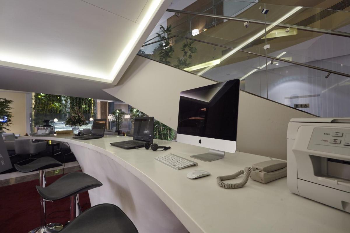 an office with a desk with a computer on it at Turyaa Chennai - OMR IT Expressway in Chennai