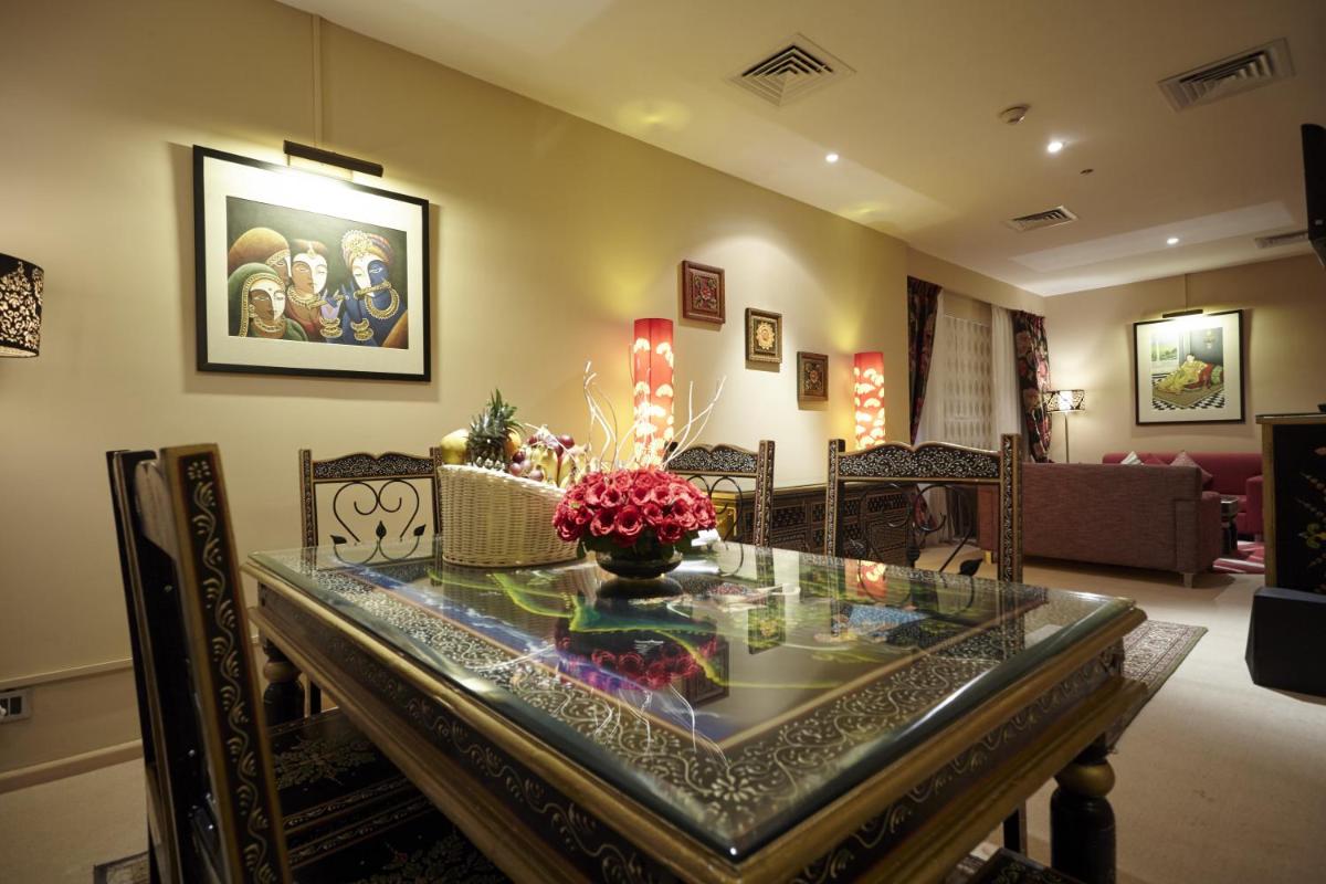 a dining room with a glass table and chairs at Turyaa Chennai - OMR IT Expressway in Chennai