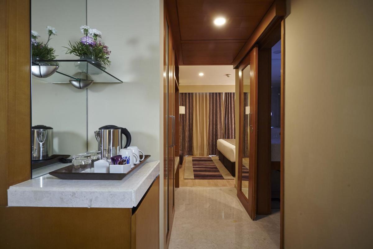 a kitchen with a sink and a counter top at Turyaa Chennai - OMR IT Expressway in Chennai